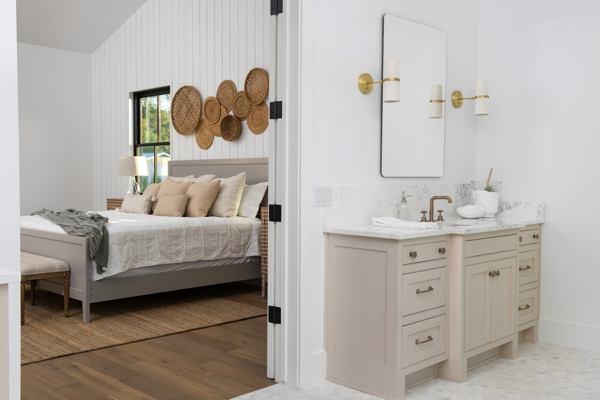 Primary suite with shiplap accent wall, textured linens, and en-suite bath